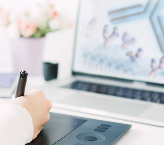 computer with scientific image, hand holding pen