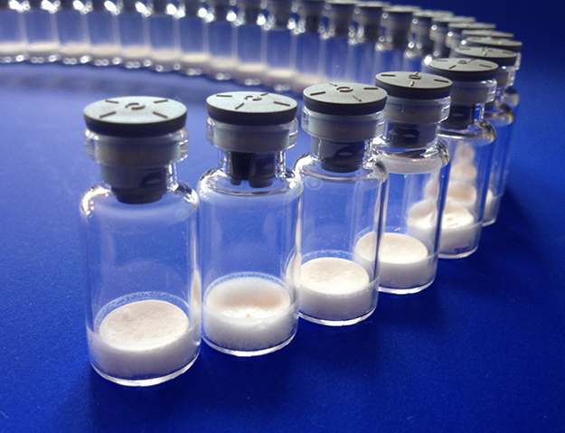 Examples of glass vials with lyophilized cake inside.